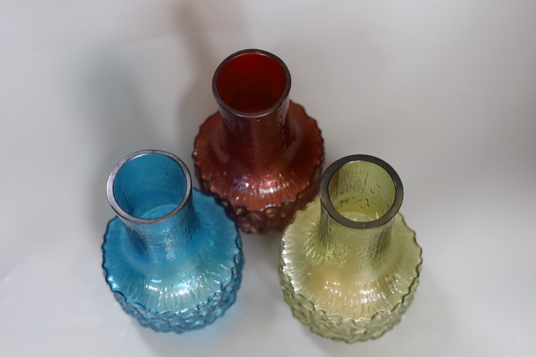 Three Whitefriars cylindrical bottle vases, in red, kingfisher blue and sage green glass (3) each 18cm high.